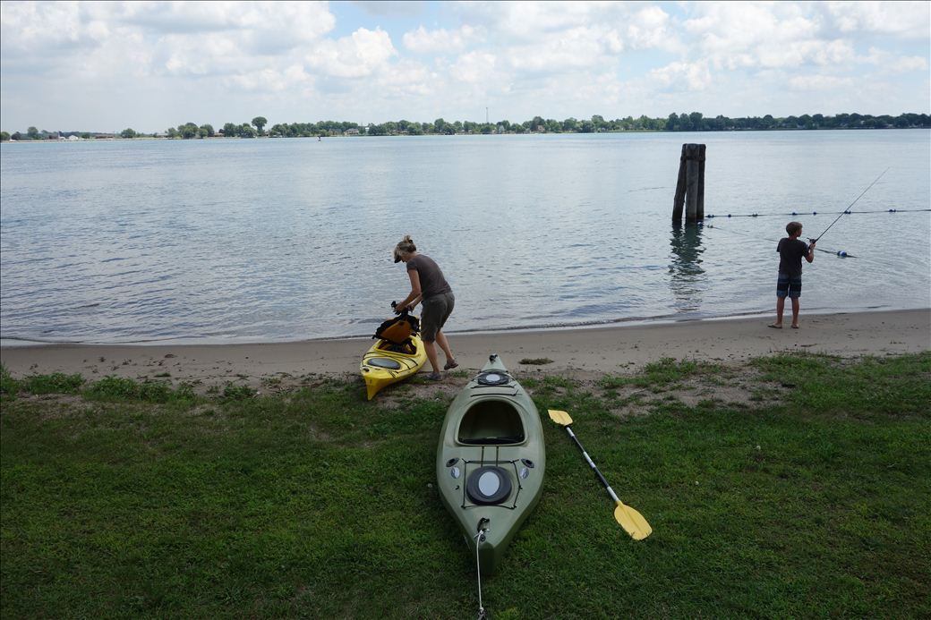 Person preparing a kayak for launch